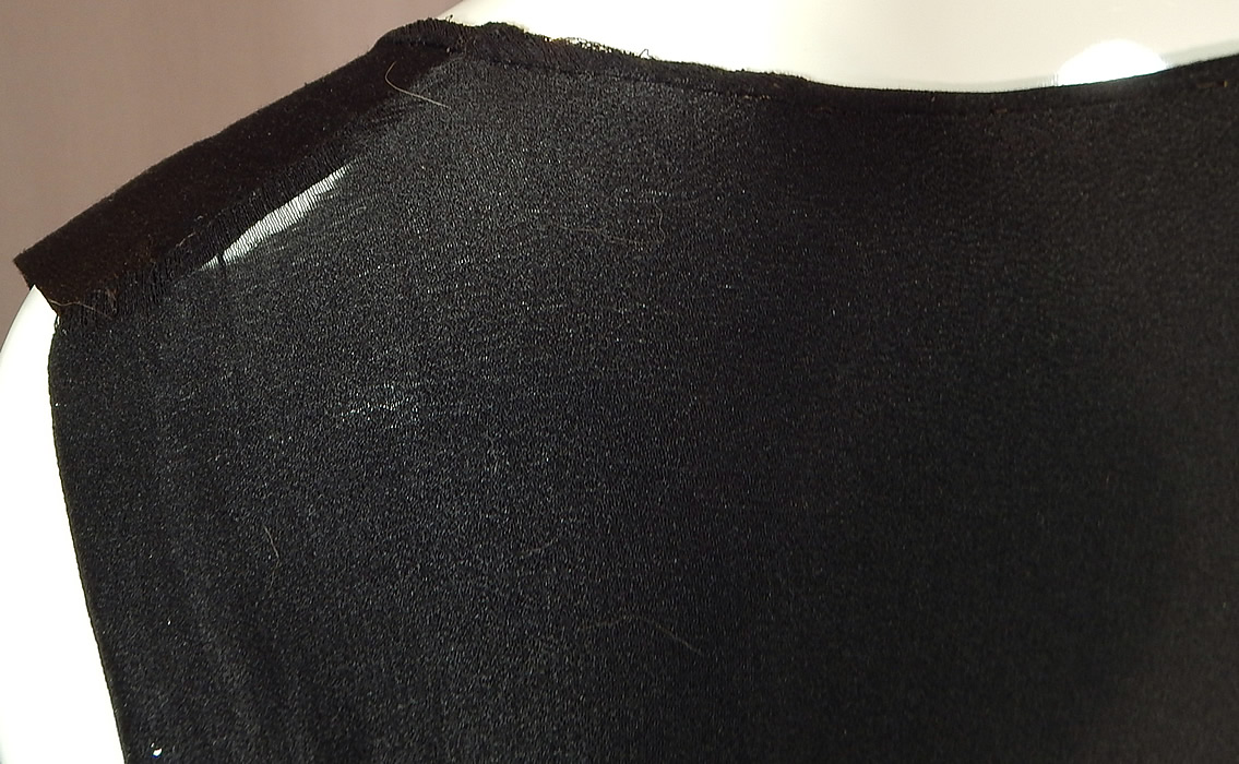 Vintage Black Silk Crepe de Chine Knotted Fringe Flapper Tabard Tunic Dress
The dress measures 39 inches long, with 8 inch long fringe, a 36 inch bust, 34 inch waist and 36 inch hips. It is in fair as-is condition, with a frayed split under one arm and back shoulder (see close-ups). 