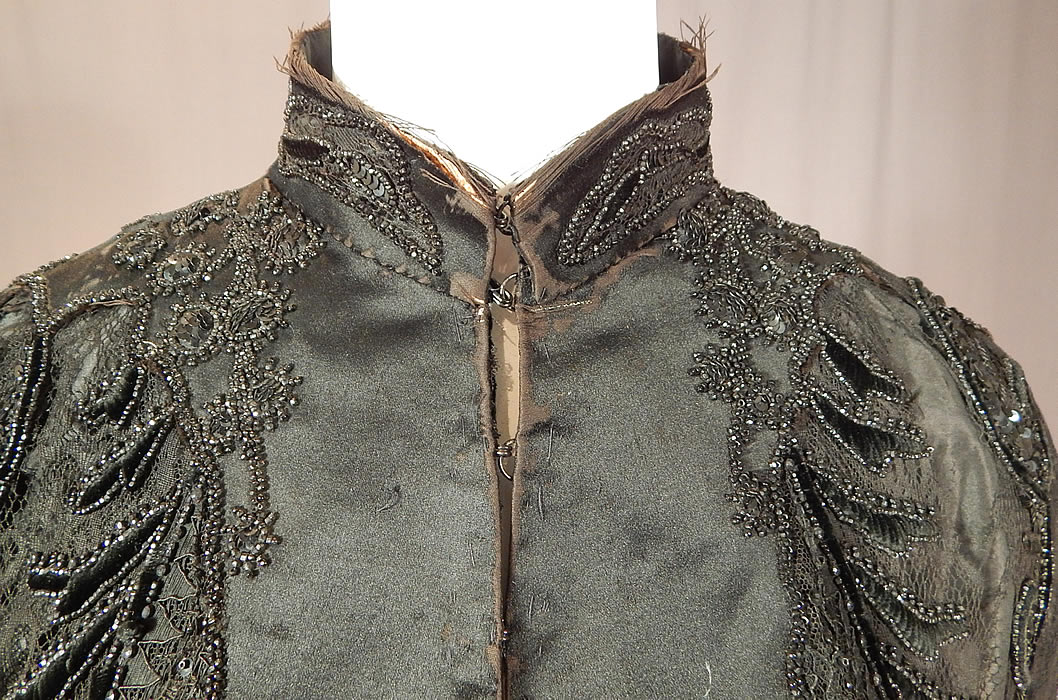 Victorian Hubert & Riqueur Paris Label Black Silk Lace Jet Beaded Mantle Cloak Cape
This beautiful beaded evening mantle cloak cape has a fitted long mid length style, with a beaded high band collar, hook closures down the front, an inside silk strap tie at the waist and is fully lined inside with a black silk taffeta fabric lining. 