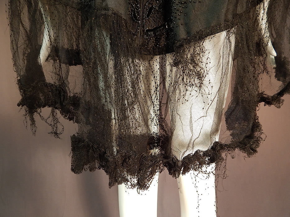 Victorian Hubert & Riqueur Paris Label Black Silk Lace Jet Beaded Mantle Cloak Cape
It is in fair as-is condition, with several small frayed splits on the inside silk lining which should be removed and replaced, fraying along the collar, bottom tulle net trim and a few loose missing beads (see close-ups). This is truly a rare and outstanding piece of antique Victoriana Parisian designer couture wearable beaded art! 