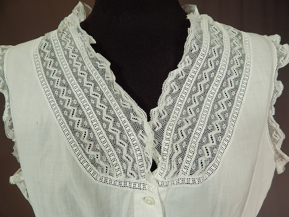 Victorian Lingerie White Cotton Batiste Lace Trim Camisole Corset Cover Top
There is a red monogrammed initial label sewn inside the bottom front opening. This lovely lacy lingerie camisole corset cover top undergarment has a form fitting style, sleeveless, with lace trim V neckline, peplum skirted waist and tiny mother of pearl button closures down the front.