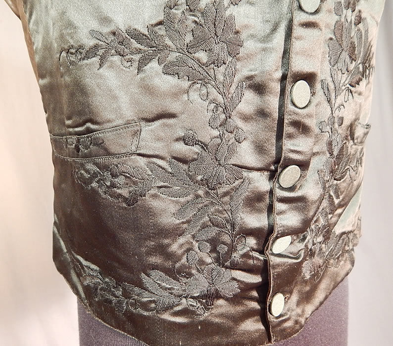 Victorian Gentleman's Black Silk Floral Leaf Embroidered Mourning Waistcoat Vest
It is fully lined with cotton batting padding inside the front chest area. This dapper gentleman's mourning waistcoat vest has a V front opening, with a embroidered fold over lapel collar, three front pockets and six silk fabric covered buttons for closure on the front. 