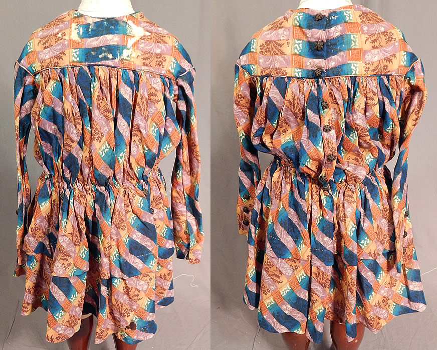 Victorian Civil War Era Childs Floral Patchwork Plaid Print Wool Button Back Dress
This antique Victorian Civil War era child's floral patchwork plaid print wool button back dress dates from the 1860s. It is hand stitched, made of a colorful indigo blue, mauve purple and brown floral leaf, plaid patchwork print fine wool fabric.