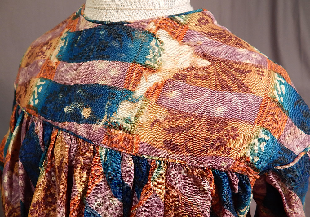 Victorian Civil War Era Childs Floral Patchwork Plaid Print Wool Button Back Dress
The dress measures 22 inches long, with a 26 inch chest, 20 inch waist, 13 inch long sleeve and 12 inch back. It is in fair as-is condition, with frayed holes on the front yoke which have been backed, patched, some staining on the inside and a frayed hole on the bottom front skirt (see close-ups). 