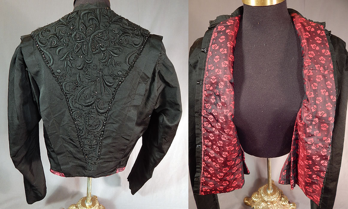 Victorian Black Silk Embroidered Jet Beaded Bodice Coat Jacket
This beautiful black beaded bodice coat jacket has a fitted tailored style, with the embroidered bead work done along the front and back V panels, has long sleeves, a band collar, hook closure down the front and is fully lined in a red and black floral pattern iridescent silk damask weave fabric inside. 