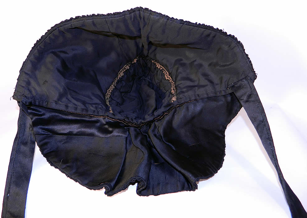 Victorian Civil War Era Black Silk Quilted Winter Mourning Sun Bonnet. he bonnet measures 20 inches deep, 18 inches wide and 22 inch circumference around the face. It is in good condition, with only a few small frays on the back curtain drape. There is a note of provenance that belonged to Mary Stewart". 