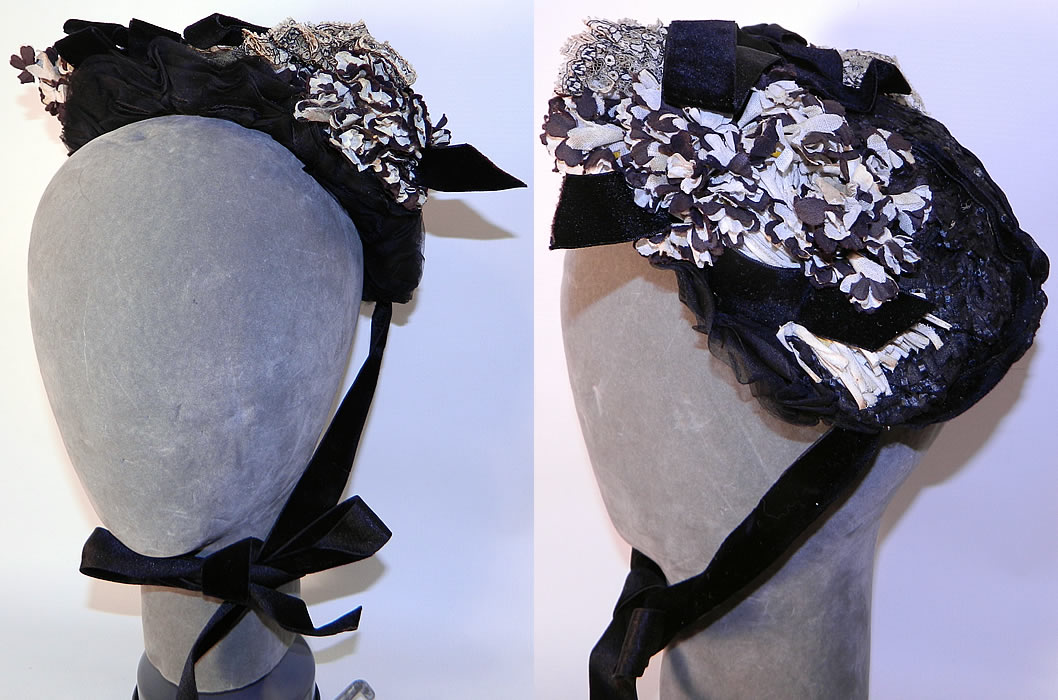 Victorian Black & White Violet Flower Lace Trim Straw Bonnet Hat. It is made of a woven black straw base, with black velvet ribbon bow trim and sheer black silk chiffon fabric ruffle gathers around the inside the front brim.