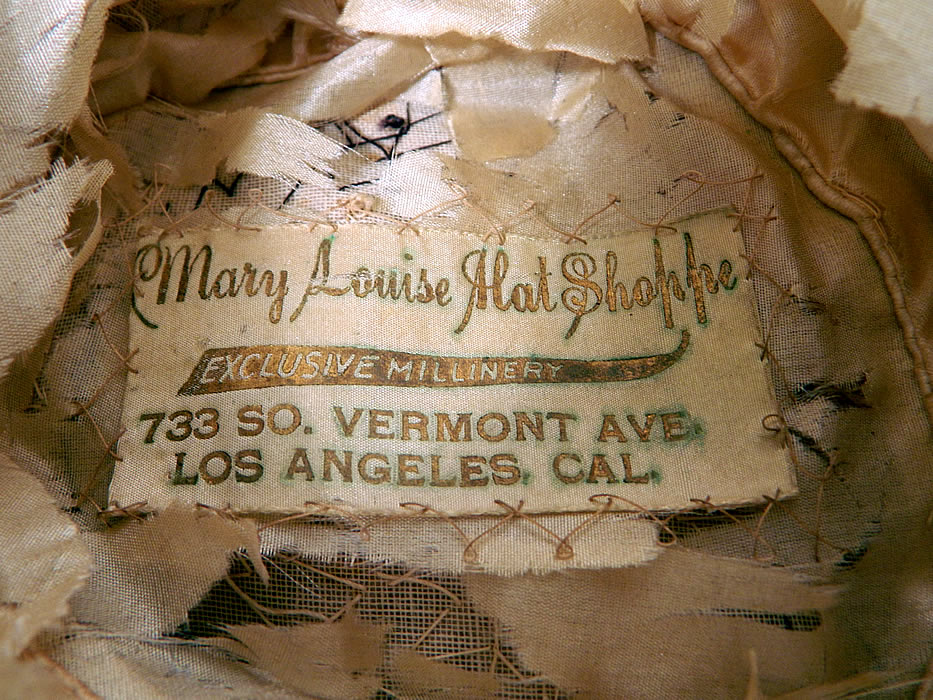 Vintage Silk Ribbon Crimp Curl Striped Rainbow Flapper Cloche Hat. It is lined inside in a silk fabric which is shattered and there is a "Mary Louise Hat Shoppe Exclusive Millinery 733 So. Vermont Ave. Los Angeles, Calif." label. 
