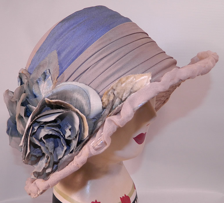 Vintage Maurice Importer Gray & Blue Silk Rose Flower Wide Brim Cloche Hat. This vintage Maurice Importer gray and blue silk rose flower wide brim cloche hat dates from the 1920s.