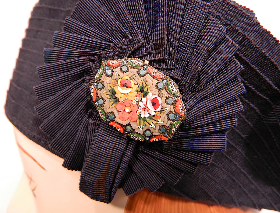 Vintage Eva Mae Navy Blue Pleated Beret Tam Hat & Italian Micro Mosaic Brooch Pin. There is a rosette trim on the side with an Italian micro mosaic brooch pin oval shaped with tiny flowers.