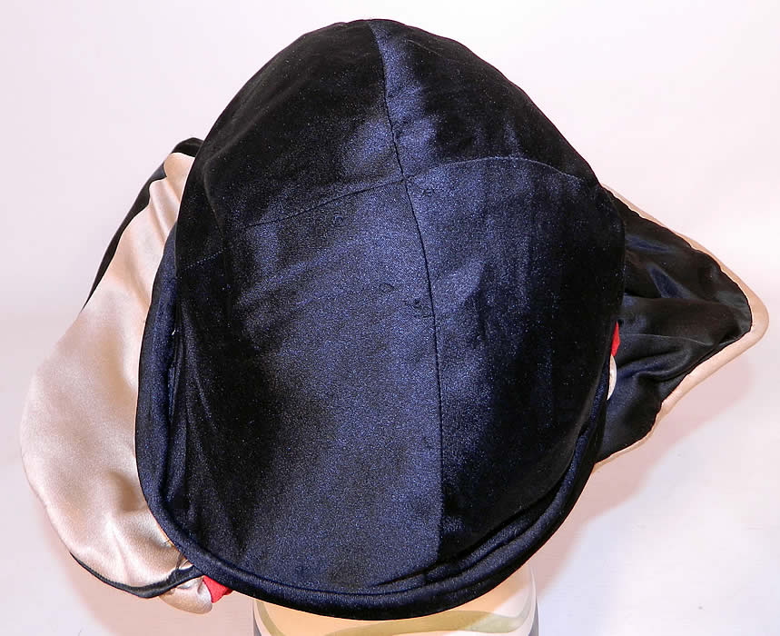 Vintage Art Deco Black & White Silk Red Rosette Wired Wing Brim Flapper Cloche Hat. It is in good condition, with only a couple of tiny frays along the wired brim edging.