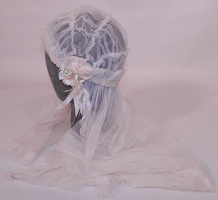 Vintage White Net Lace Silk Ribbon Bridal Bonnet Cap Headpiece Wedding Veil. There is cream silk ribbon ruched gathering trim around the cap, with rosette ribbon trim on the sides and tiny lily of the valley flowers. 