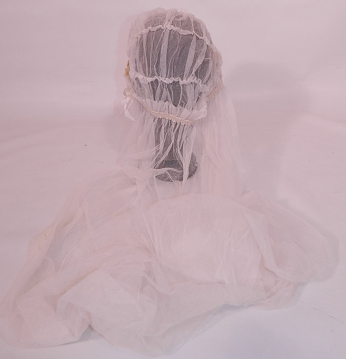 Vintage White Net Lace Silk Ribbon Bridal Bonnet Cap Headpiece Wedding Veil. The cap measures 27 inches in circumference and the net veil measures 43 inches long, 43 inches wide. It is in excellent condition. This wonderful wedding bridal veil headpiece is a beautiful one of a kind piece of antique textile art! 