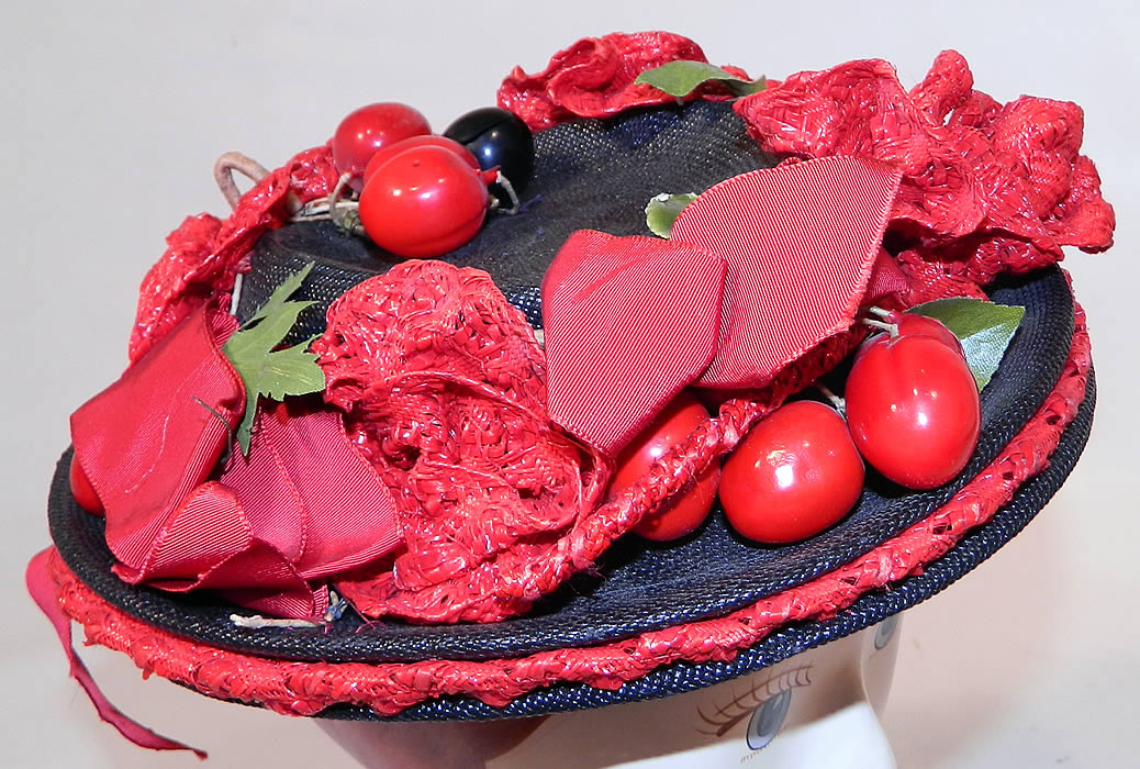 Vintage Red Straw Roses Cherries Small Skimmer Boater Tilt Hat Fascinator. This vintage red straw roses cherries small skimmer boater tilt hat fascinator dates from the 1940s.