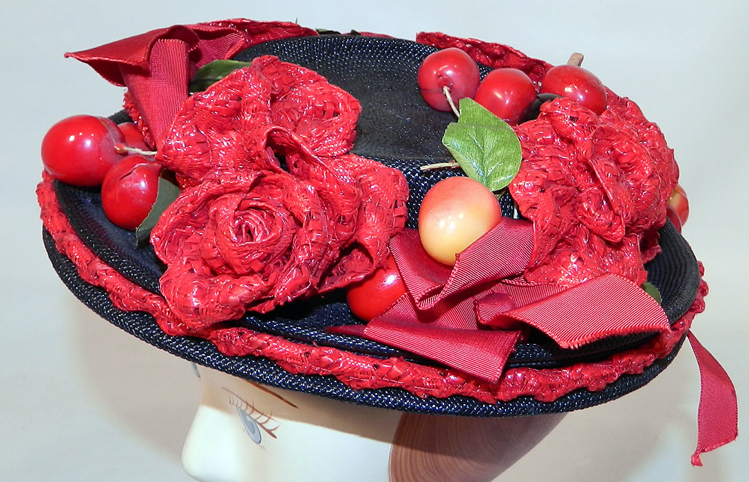 Vintage Red Straw Roses Cherries Small Skimmer Boater Tilt Hat Fascinator. This unique whimsical miniature small skimmer boater style ladies doll hat fascinator cocktail hat tilts down, with hooks underneath to grasp and hold in place. 