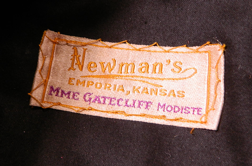 Edwardian Vintage Madame Gatecliff Modiste Black Velvet Lace Feather Trim Wide Brim Hat. There is a black silk lining inside the crown, with a "Newman's Emporia, Kansas Mme Gatecliff Modiste" label. 