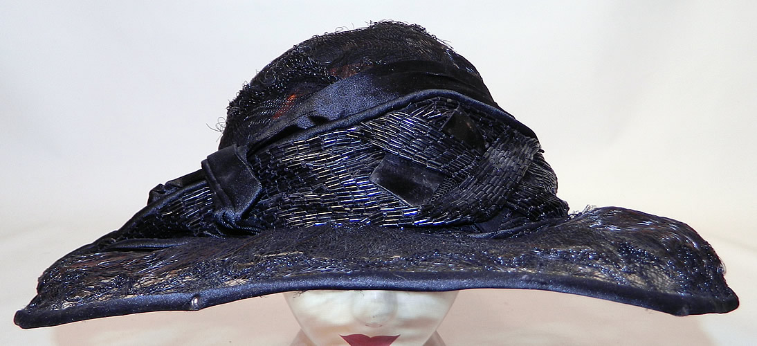 Vintage Burke Beaded Black Woven Horse Hair Straw Sheer Wide Brim Cloche Hat
The hat is made of a wire base, covered with a sheer woven black horse hair net straw and black silk trim edging. 