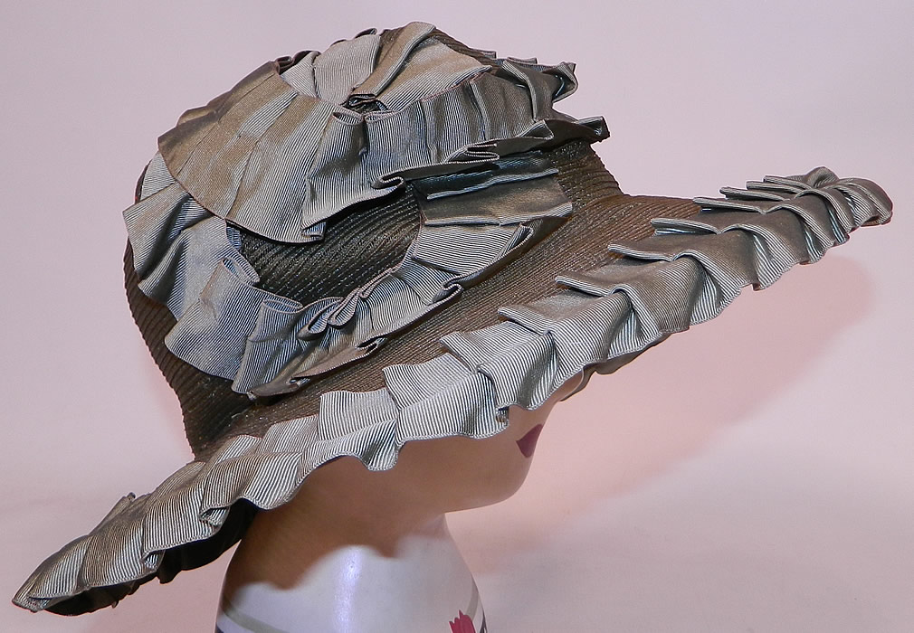 Vintage Sage Green Straw Silk Ribbon Ruffle Trim Wide Brim Cloche Hat
It is made of a sage green color woven straw, with matching silk grosgrain ribbon ruched ruffle trim edging. This fabulous flapper cloche style hat has a form fitting style with an uneven asymmetrical oval shape wide brim, which is wider along the sides and front.