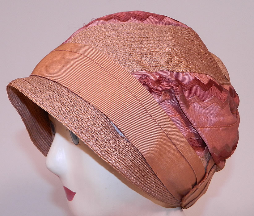 Vintage Art Deco Tango Pink Silk Ribbon & Woven Straw  Flapper Cloche Hat 
This vintage Art Deco tango pink silk ribbon woven straw flapper cloche hat dates from the 1920s.