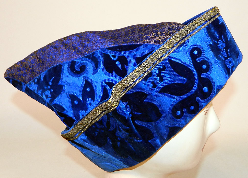 Vintage Hungary Regional Folk Costume Blue Burnout Voided Velvet Gold Trim Cap Archers Hat
It is made of a royal blue burnout voided velvet fabric with a floral leaf design, gold & blue silk fabric flower square print on top, gold bullion metal soutache embroidery and braided rope trim edging.