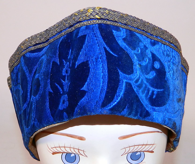 Vintage Hungary Regional Folk Costume Blue Burnout Voided Velvet Gold Trim Cap Archers Hat
This Hungarian hat archers bonnet style alpine cap was part of the traditional folk costume worn by the men of Hungary, with a floppy pointed top, rolled brim winged sides and is fully lined in silk with leather trim edging around the inside bottom. 