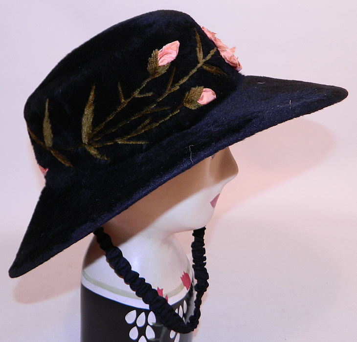 Edwardian Belle Epoque Black Plush Velvet Pink Silk Rosette Embroidered Wide Brim Hat
This beautiful Belle Epoque hat has a wide brim, round crown, a black silk pleated ruched strap "wind string" attached underneath to keep from flying off and is lined in black silk inside the crown. 