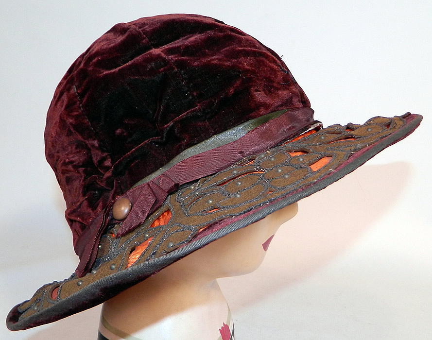 Vintage Burgundy Velvet Orange Silk Brown Cutwork Beaded Trim Wide Brim Cloche Hat
This fabulous flapper cloche style hat has a form fitting style with an uneven asymmetrical oval shape wide brim, which is wider along the sides and front. 
