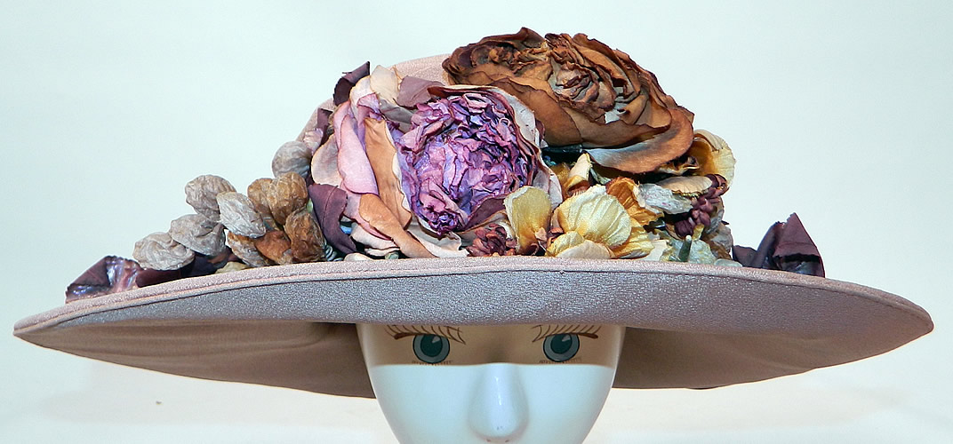 Edwardian Belle Epoque Taupe Silk Autumn Fall Floral Foliage Trim Wide Brim Hat
It is made of a grayish brown taupe color silk fabric, with colorful autumn fall foliage silk flowers and leaf trim on the front.