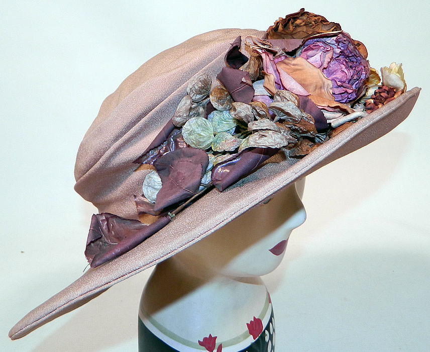 Edwardian Belle Epoque Taupe Silk Autumn Fall Floral Foliage Trim Wide Brim Hat
This beautiful Belle Epoque hat has an uneven asymmetrical oval shape wide brim, which is wider along the sides, a slouched draped fabric round crown and is fully lined. 