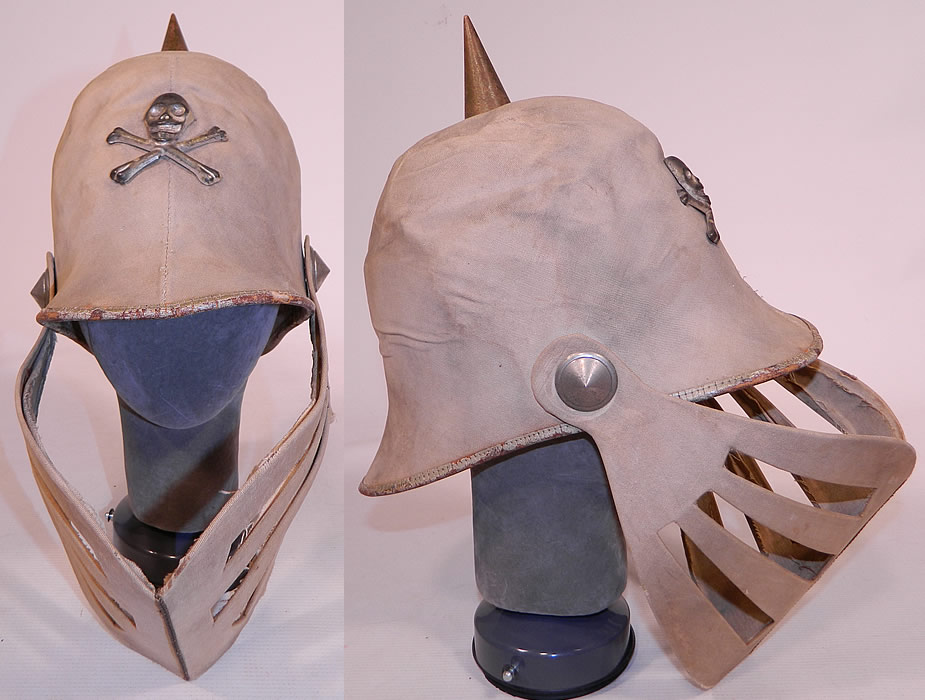 Vintage Odd Fellows Fraternal Skull Cross Bones Knights Louvered Visor Helmet Hat
This vintage antique Odd Fellows fraternal skull cross bones knights louvered visor helmet hat dates from 1900. It is made of an off white ecru cream color cotton canvas twill fabric covering a stiffened paper base, with a silver tone metal skull & crossbones insignia on the front and spike on top.