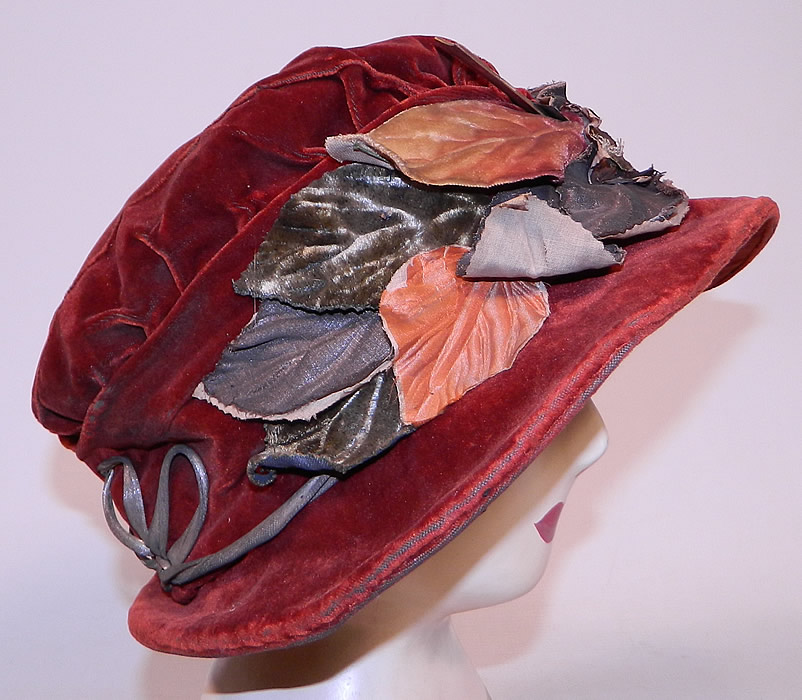Vintage Autumn Burgundy Red Velvet Silver Lame Leaf Trim Wide Brim Cloche Hat Lam&eacute;
This autumn fall color inspired hat has an uneven asymmetrical oval shaped brim, which is wider along the sides and a muffin top slouched crown. 