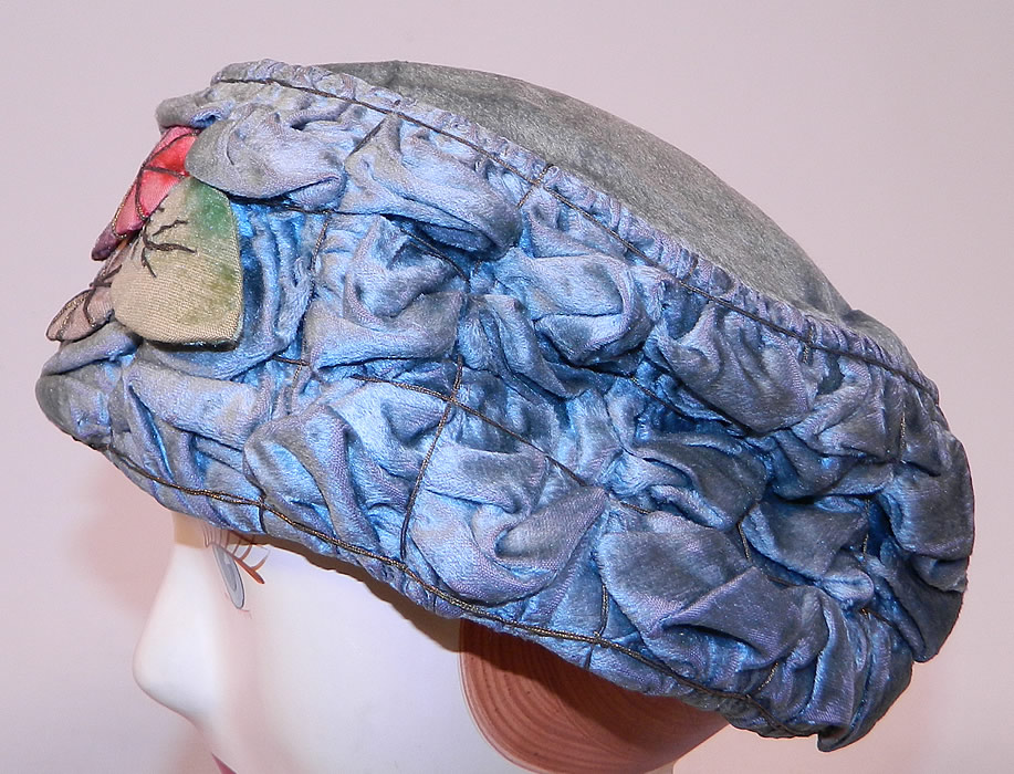 Vintage Ruched Cornflower Blue Gray Velvet Silver Lame Leaf Trim Toque Cloche Hat Lamé
The hat is made of a cornflower blue gray color velvet fabric with ruched tucks gathering, silver lamé thread binding and colorful velvet leaf trim on the front.