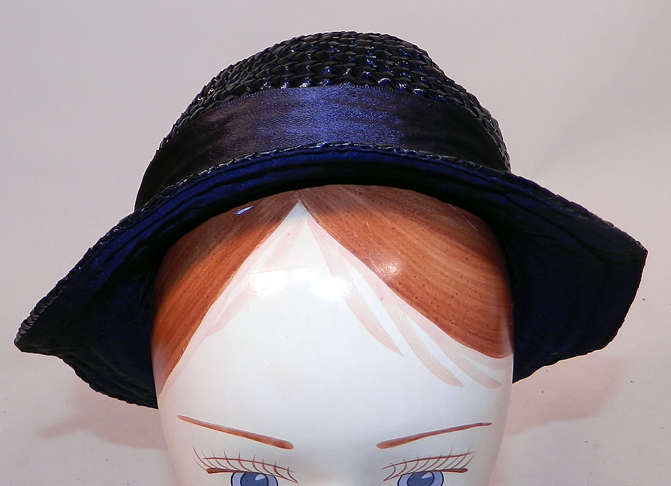 Vintage Navy Blue Woven Straw Red Cherry Silk Ribbon Bow Trim Childs Cloche Hat
This charming child's cloche style hat has an uneven asymmetrical oval shape brim which is wider on the sides and front, a small round crown and is lined only along the underneath inside brim.