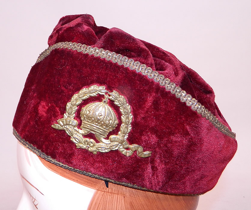 Vintage Fraternal Freemasonry Masonic Past Grand Master Red Velvet Gold Trim Cap Hat
It is made of a dark red burgundy wine color plush velvet fabric with gold lamé braided trim edging and a gold metal laurel wreath crown medallion sewn onto the side.