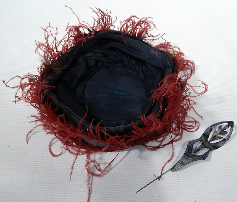 Vintage McGrath Millinery Belle Epoque Burgundy Velvet Feather Trim Toque Hat
This beautiful Belle Epoque brimless toque style hat comes with a decorative cut out metal hat pin and is fully lined in black cotton with a "McGrath Millinery Hoosick Falls, N.Y." label inside. 
