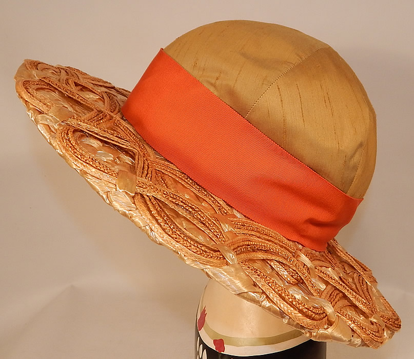 Vintage Schiaparelli Paris Yellow Orange Silk Woven Natural Straw Raffia Wide Brim Hat
Schiaparelli was strongly influenced by the modernist art of her day and her designs often have a whimsical, creative, outrageous, spectacular look.