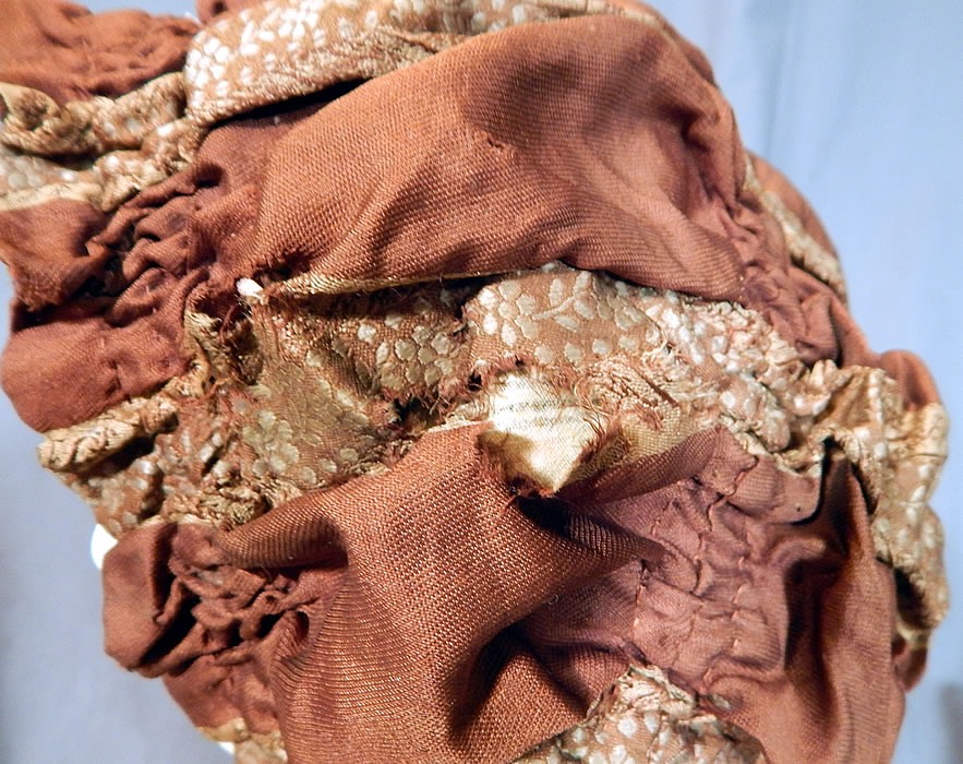 Victorian Brown Silk Ruched Ribbon Steel Cut Button Trim Carriage Bonnet Travel Cap Hat
The bonnet measures 26 inches in circumference. It is in good as-is condition, with some small frayed splits in the silk fabric side and on the silk ties (see close-up). This is truly a wonderful piece of Victoriana millinery art.