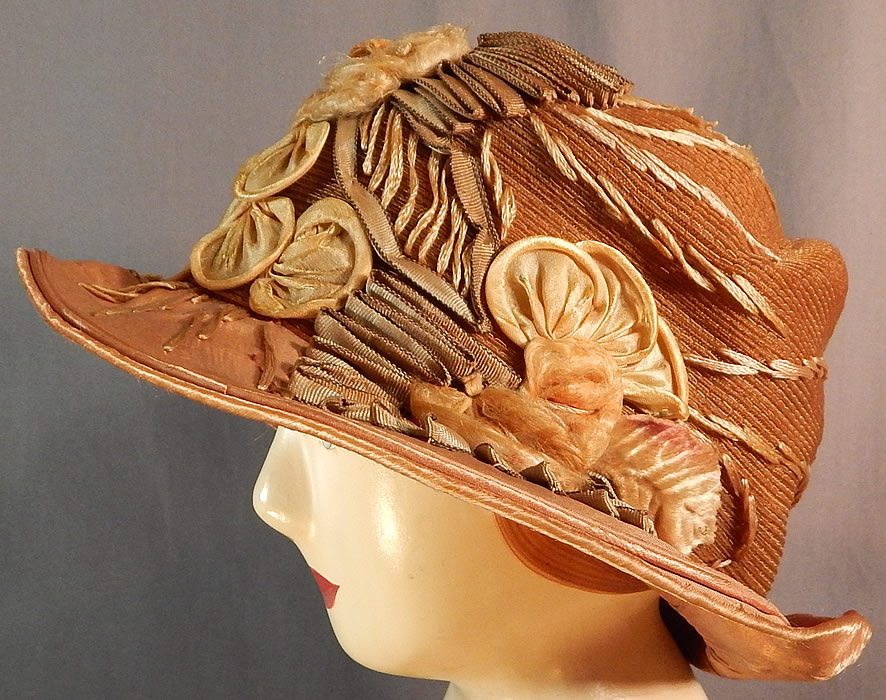 Vintage M. Lurie & Co Harvest Gold Woven Silk Ribbon Rosette Wide Brim Cloche Hat
The hat is made of a harvest gold color silk brim fabric, woven horse hair straw and ombre color silk ribbon work embroidered trim, velvet leaf, silk rosette flower trim on the crown.