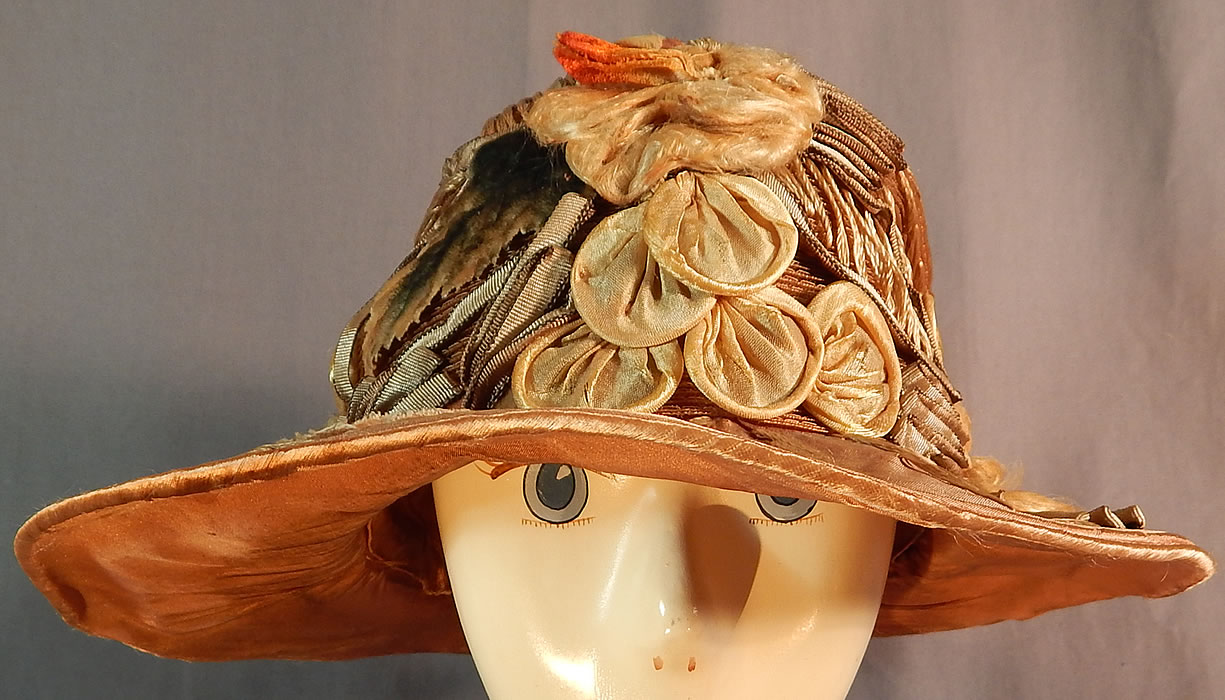 Vintage M. Lurie & Co Harvest Gold Woven Silk Ribbon Rosette Wide Brim Cloche Hat
The hat measures 22 inches inside crown circumference and 36 inches outside. 