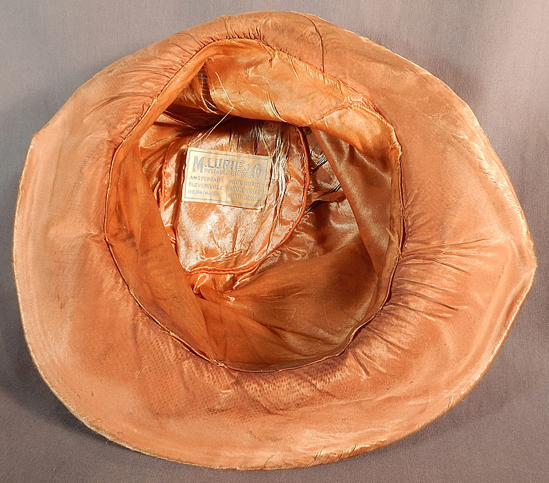 Vintage M. Lurie & Co Harvest Gold Woven Silk Ribbon Rosette Wide Brim Cloche Hat
It is fully lined, with the same golden iridescent silk fabric and has a "M. Lurie & Co. Reliable Stores" label inside. 