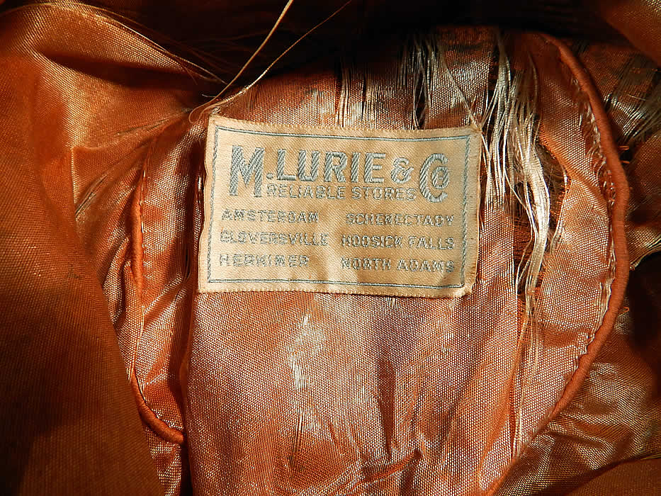 Vintage M. Lurie & Co Harvest Gold Woven Silk Ribbon Rosette Wide Brim Cloche Hat
It is fully lined, with the same golden iridescent silk fabric and has a "M. Lurie & Co. Reliable Stores" label inside. 