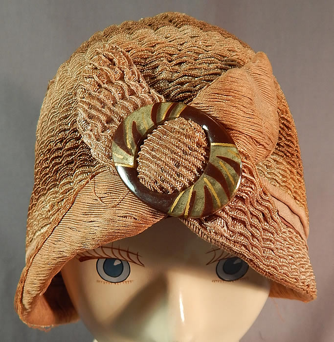 Vintage Art Deco Striped Brown Ombre Woven Straw Flapper Cloche Hat & Buckle
The hat is made of a graduated light to dark shades of brown ombre woven horse hair net straw with a wavy scalloped style.