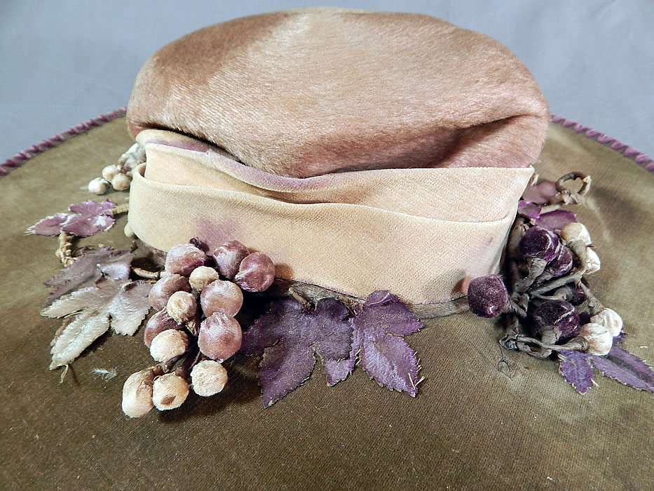 Edwardian Lavender Purple Gray Velvet Grape Berry Leaf Large Wide Brim Hat
It is made of a grayish light purple lavender color velvet fabric, with purple chenille whip stitching trim edging the wired brim.