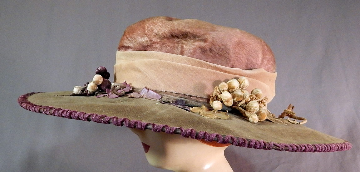 Edwardian Lavender Purple Gray Velvet Grape Berry Leaf Large Wide Brim Hat
There is a faded purple velvet ribbon hatband, purple velvet covered three dimensional clusters of grape berries, vine branches and silk grape leaf trim.