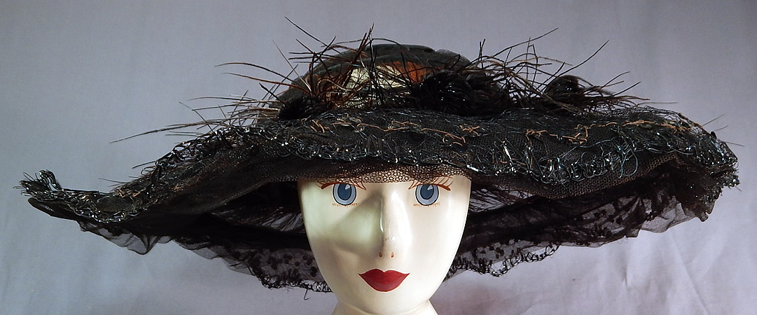 Edwardian Black Tulle Net Sequin Feather Trim Large Wired Wide Brim Hat
The hat measures 19 inches wide across the brim, 56 inches in circumference on the outside and has a 22 inch inside crown circumference. 