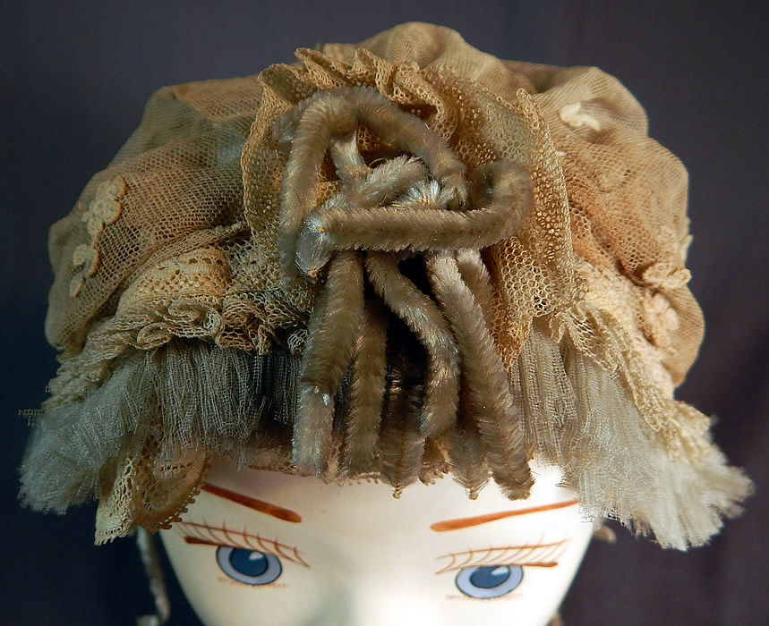 Victorian Cream Tulle Net Lace Blue Silk Chenille Trim Bed Cap Bonnet Hat
It is in good as-is condition with some fraying along the ruffle trim edging, inside silk lining and has some dingy dirty discoloration. This is truly a wonderful piece of home made millinery textile art! 