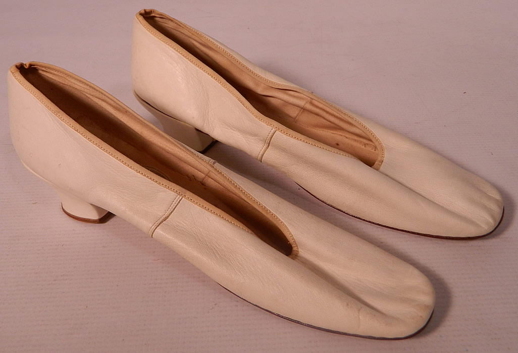 Victorian Henry H Tuttle & Co Boston Label White Kid Straight Sole Shoes. They are hand stitched and made of an off white ivory color kid leather. These ladies slipper shoes have squared toes, straight leather bottom soles with no left or right distinction and a low leather covered French Louis XV high heel.