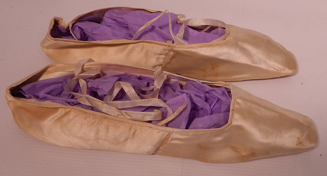 Antique Pradel Huet Paris Label White Silk Ribbon Tie Straight Sole Shoes. The shoes measure 9 inches long and 2 inches wide. They have been gently worn, with some small faint age spot. water stains and few tiny frays in the silk along the bottom edging. These delicate slippers were reserved for indoor wear, evening dress or special occasions. These are truly a rare and early find!