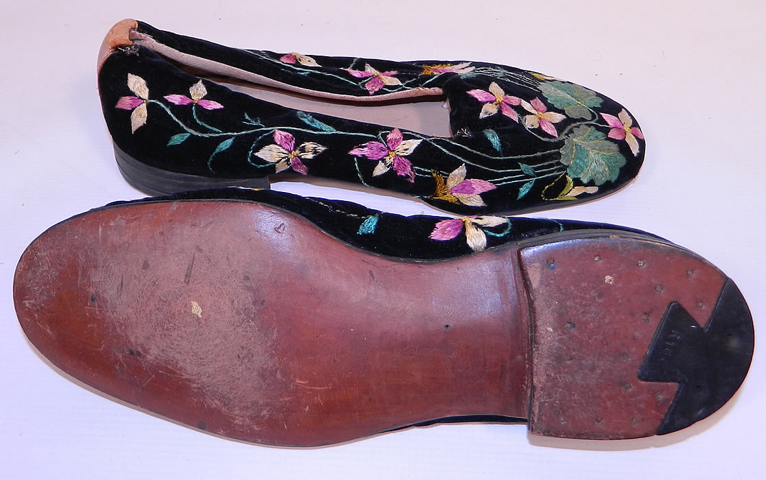 Victorian Black Velvet Violet Embroidered Men's Slipper Shoes. The shoes measure 10 1/2 inches long, 3 1/2 inches wide, with a 1 inch high heel. They are in good condition and have been gently worn, with some minor wear.