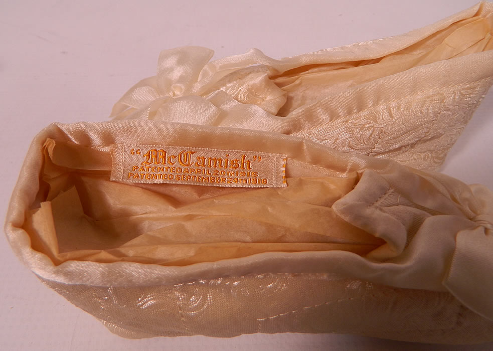 Vintage McCamish Funeral Burial Child's White Satin Slipper Shoes. They have elastic bands which can conform to any width foot and are lined in a quilted white satin with white satin bottom soft soles. 