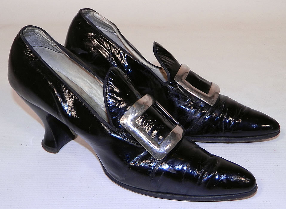 Edwardian Black Patent Leather Silver Buckle Pilgrim Witch Style Shoes. These whimsical wicked witch Colonial pilgrim style shoes have a slip on style, with long pointed toes, a flared tongue and large silver buckle trim on the front instep vamps. 